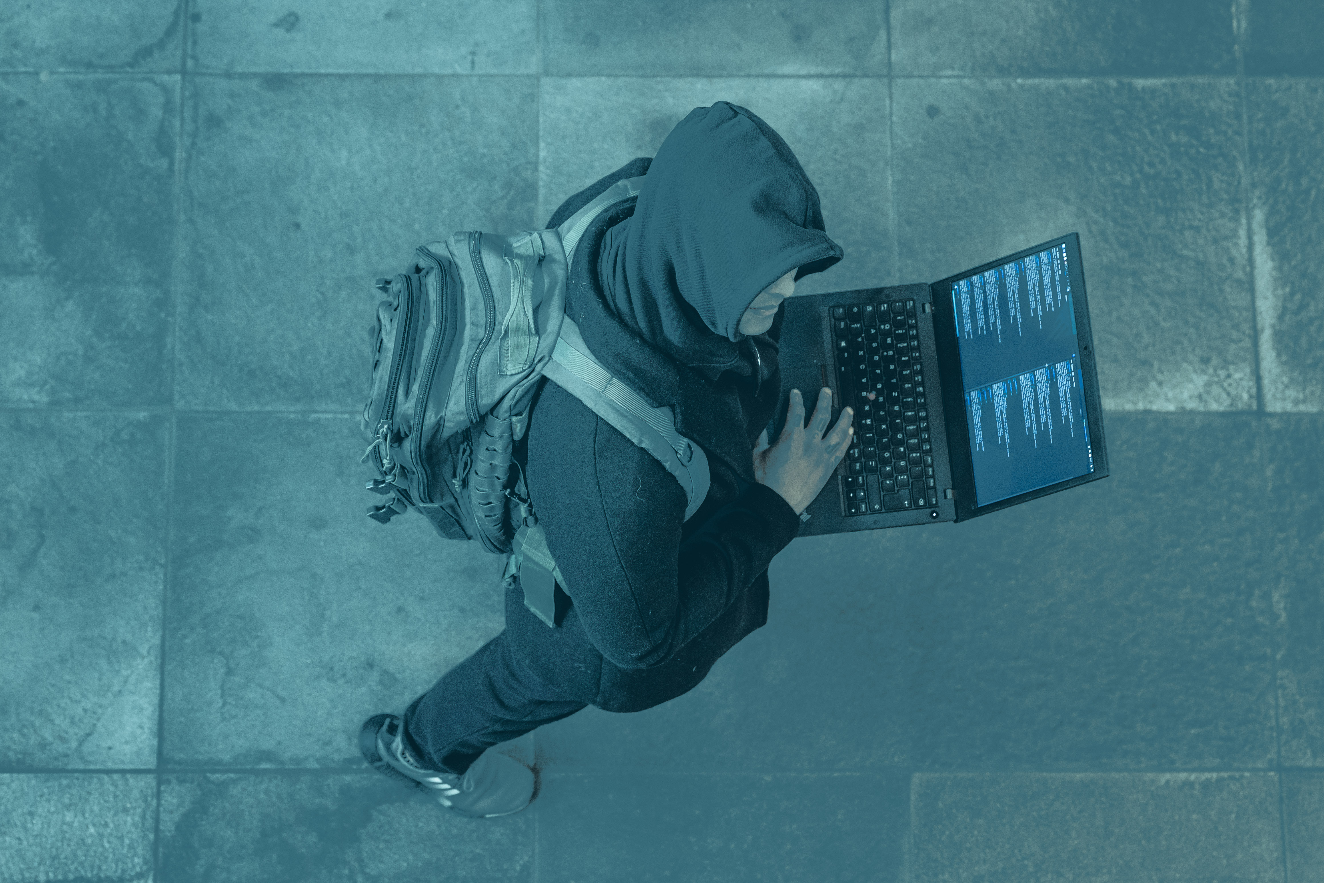 Gabriel working on a laptop in an urban environment